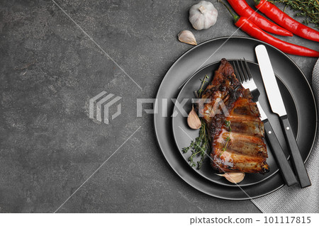 Tasty grilled ribs served on grey table, flat lay. Space for text Tasty grilled ribs served on grey table, flat lay. Space for text 101117815