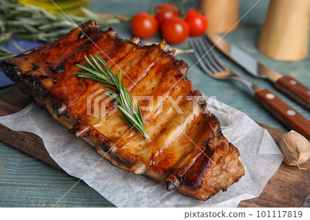 Tasty grilled ribs with rosemary on table Tasty grilled ribs with rosemary on table 101117819