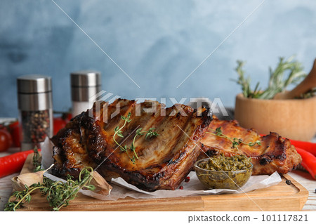 Tasty aromatic grilled ribs with thyme served on table 101117821