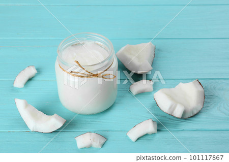 Composition with organic coconut oil on light blue wooden table. Healthy cooking 101117867