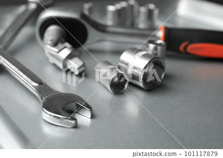 Auto mechanic's tools on metallic surface, closeup 101117879