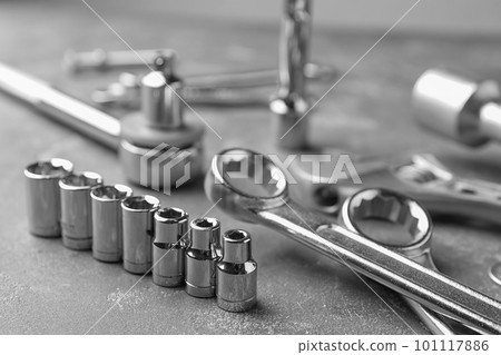 Auto mechanic's tools on grey stone table Auto mechanic's tools on grey stone table 101117886
