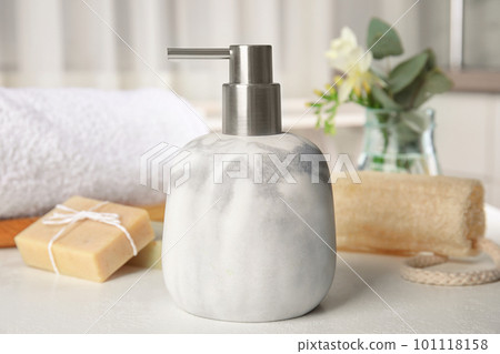 Soap dispenser and toiletries on white table Soap dispenser and toiletries on white table 101118158