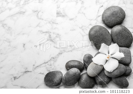 Stones and orchid flower on marble background, top view with space for text. Zen lifestyle Stones and orchid flower on marble background, top view with space for text. Zen lifestyle 101118223