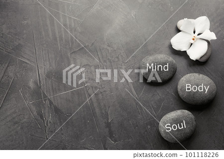 Stones with words MIND, BODY, SOUL on grey background, top view with space for text. Zen lifestyle Stones with words MIND, BODY, SOUL on grey background, top view with space for text. Zen lifestyle 101118226