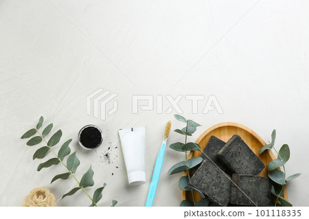Flat lay composition of toothbrush with natural bristles on white table. Space for text Flat lay composition of toothbrush with natural bristles on white table. Space for text 101118335