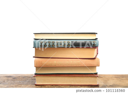 Stack of old vintage books on wooden table against white background Stack of old vintage books on wooden table against white background 101118360