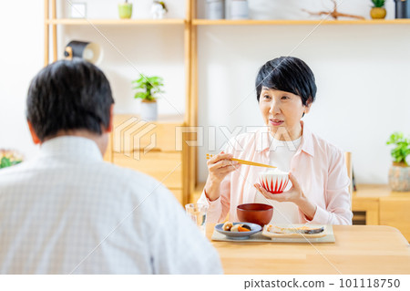 Senior couple eating in the dining room Senior couple eating in the dining room 101118750