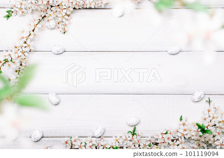 Easter flat. Cherry tree blossom, white happy easter eggs on wood spring background. Springtime concept.  101119094