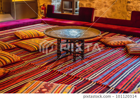 Turkish traditional antique carpets interior. table and pillows 101120314