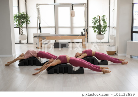 Balanced Body Pilates Arc. Three asian women exercising on pilates arc. Balanced Body Pilates Arc. Three asian women exercising on pilates arc. 101122659