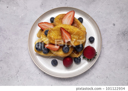 Flatly French Toast, Spanish Torrijas Made Of Sliced Baguette, Bread, Served With Orange Topping, Glaze, Fresh Blueberries, Strawberry On Plate, Granite Table. Morning Dessert. Horizontal plane 101122934