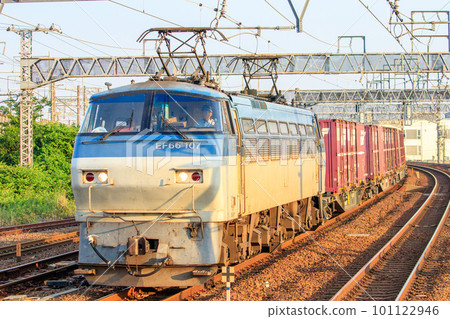Freight train hauled by EF66 running near Biwajima Station in the morning sun Freight train hauled by EF66 running near Biwajima Station in the morning sun 101122946