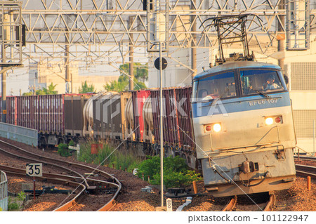 Freight train hauled by EF66 running near Biwajima Station in the morning sun Freight train hauled by EF66 running near Biwajima Station in the morning sun 101122947