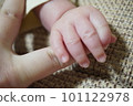 Photo of a baby's hand holding an adult's finger Photo of a baby's hand holding an adult's finger 101122978
