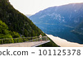 Young man standing on the viewing platform with drone controller view of Hallstatt lake, mountains 101125378
