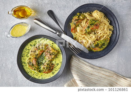 Chkemeruli, noodles with fried chicken, on a dark plate with cut Chkemeruli, noodles with fried chicken, on a dark plate with cut 101126861