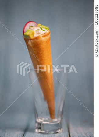 Brick cone with tuna sauce, mayonnaise, avocado and radish slice Brick cone with tuna sauce, mayonnaise, avocado and radish slice 101127589
