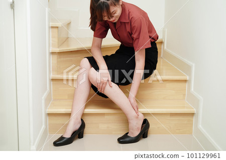 Asian business woman pain ankle, foot with leg cramp and fall down the stairs because slippery surfaces in office. Asian business woman pain ankle, foot with leg cramp and fall down the stairs because slippery surfaces in office. 101129961