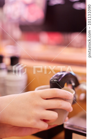 A picture of a child's hand drinking tea at a conveyor belt sushi restaurant A picture of a child's hand drinking tea at a conveyor belt sushi restaurant 101131090