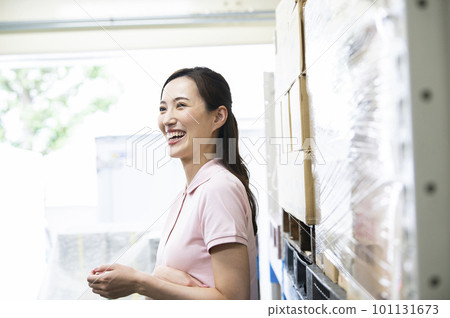 A woman working in a warehouse 101131673