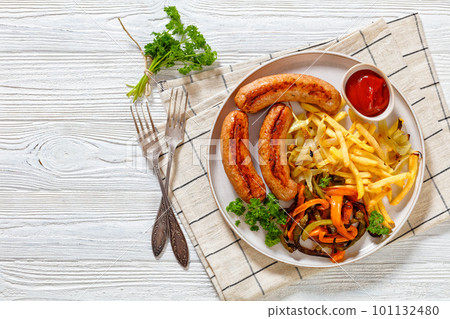 Grilled sausages, peppers, onion and french fries Grilled sausages, peppers, onion and french fries 101132480