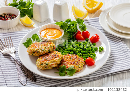 crab cakes with sauce, green peas, tomatoes 101132482
