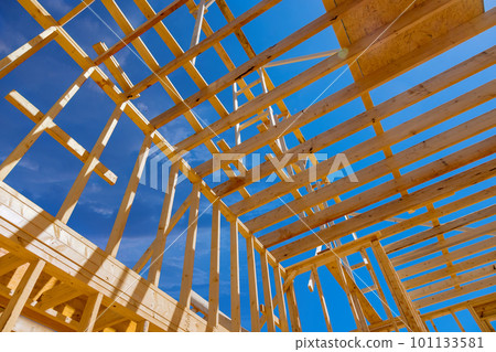Using an existing framework trusses frame wooden roof beam to support roof of newly constructed stick house 101133581