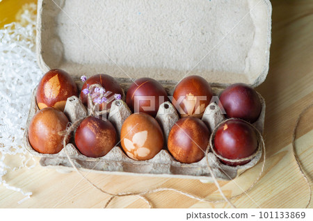 Painted eggs cooked for Easter are in an eco-friendly tray near the towel Painted eggs cooked for Easter are in an eco-friendly tray near the towel 101133869