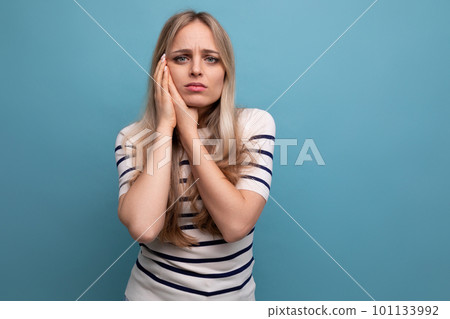 upset girl in casual clothes on a blue isolated background with copy space upset girl in casual clothes on a blue isolated background with copy space 101133992