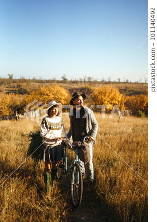 Lovely hipster couple with bike. Couple wearing beautiful hats and sweaters. Lifestyle. 101140492