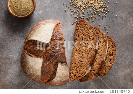 Loaf of gluten-free bread with hemp flour on brown background. Artisan bread. View from above. Loaf of gluten-free bread with hemp flour on brown background. Artisan bread. View from above. 101140740