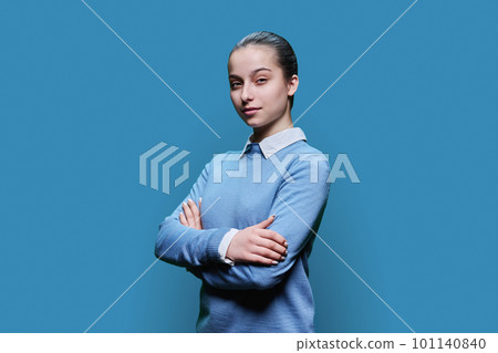 Portrait of serious high school student girl on blue background 101140840