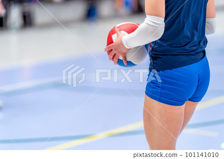 female volleyball player with the ball on the volleyball court 101141010