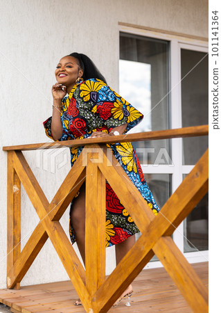 Beautiful african american woman enjoying evening on village and nature on terrace of country house. Diversity and inclusion and cottagecore concept 101141364