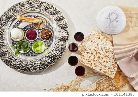 Passover Seder plate with traditional food, walnuts, matza and wine on grunge background 101141393