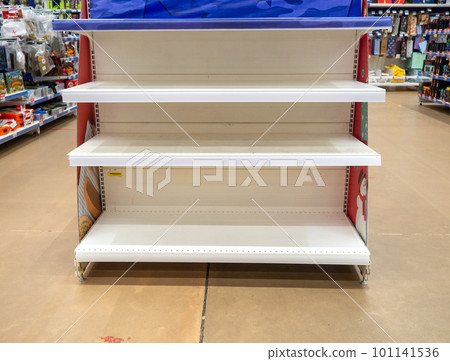 Empty shelves in the store. Laying out goods in a supermarket. 101141536