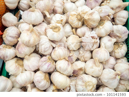 Vegetable shop. Healthy foods. Garlic on the counter. Showcase of vegetables.  Vitamin containing products 101141593