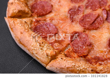 Delicious fresh pepperoni pizza with sesame seeds on the sides 101141828