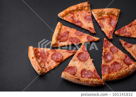 Delicious fresh pepperoni pizza with sesame seeds on the sides Delicious fresh pepperoni pizza with sesame seeds on the sides 101141832
