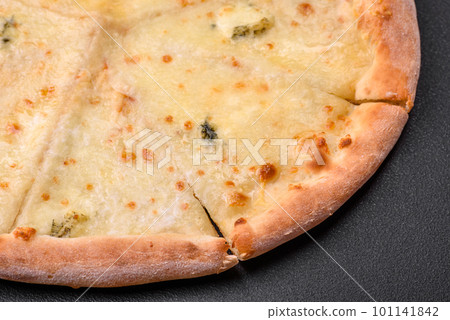 Delicious fresh hot pizza four cheeses cut into pieces Delicious fresh hot pizza four cheeses cut into pieces 101141842