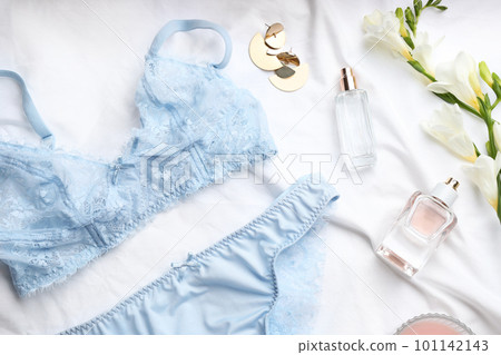 Flat lay composition with sexy women's underwear on white fabric Flat lay composition with sexy women's underwear on white fabric 101142143