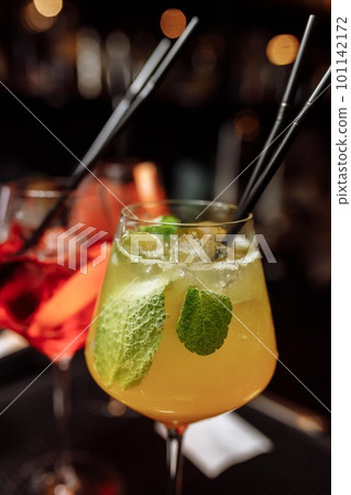 Refreshing grapefruit cocktail with ice and rosemary on a grey background. 101142172