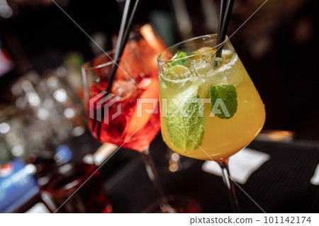 Refreshing grapefruit cocktail with ice and rosemary on a grey background. 101142174