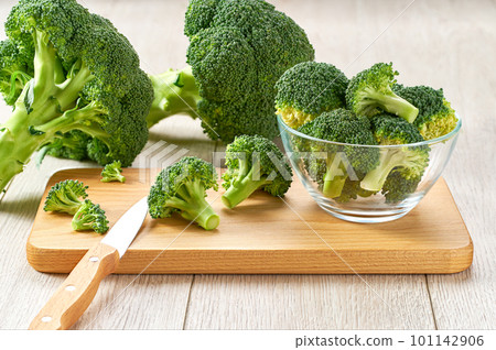 fresh raw broccoli on a cutting board, healthy food preparation. 101142906