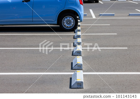 A small car parked in a parking lot A small car parked in a parking lot 101143143