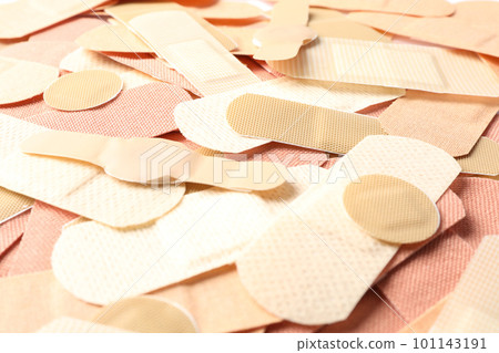 Different medical sticking plasters as background, closeup. First aid item Different medical sticking plasters as background, closeup. First aid item 101143191