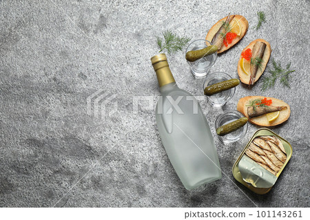 Flat lay composition with cold Russian vodka on grey table. Space for text Flat lay composition with cold Russian vodka on grey table. Space for text 101143261