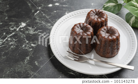 canelé on a plate canelé on a plate 101143278