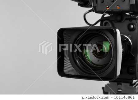 Modern professional video camera on light background, closeup Modern professional video camera on light background, closeup 101143961